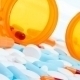 Picture of white, blue and orange pills and capsules