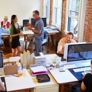 Wide Angle View Of Busy Design Office With Workers At Desks