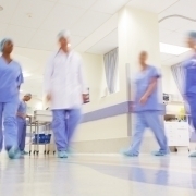 Picture of doctors working in a busy hospital corridor
