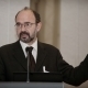 Picture of Carl Suetens speaking into a microphone at a conference